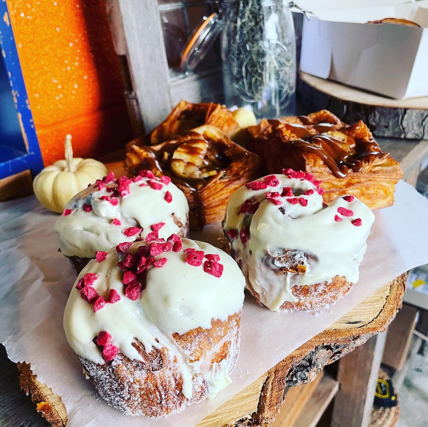 Iced buns on a wooden board